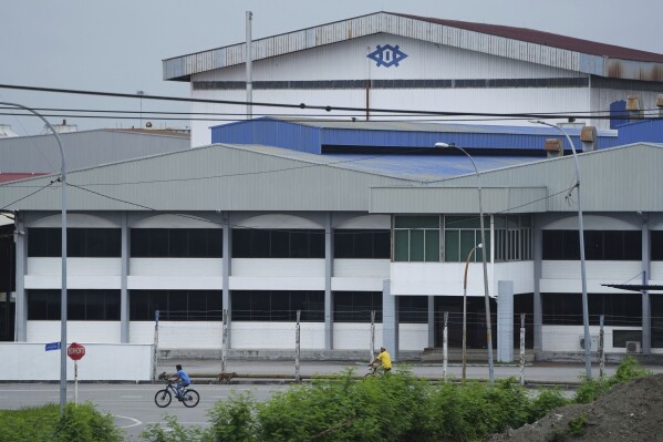 A bicycle passes in front of a Kawaguchi Manufacturing factory in Klang, Malaysia, Friday, Jan. 24, 2025. (AP Photo/Azneal Ishak)