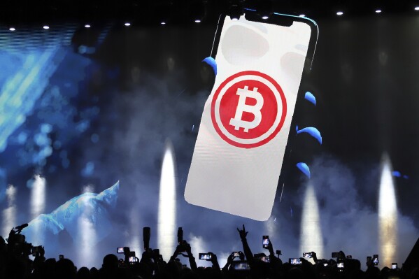 FILE - A bitcoin symbol is shown on an LED screen during the closing ceremony of a congress for cryptocurrency investors in Santa Maria Mizata, El Salvador, Nov. 20, 2021. (AP Photo/Salvador Melendez, File)