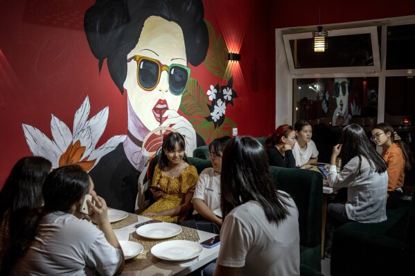 Girls eat in a restaurant in Aralsk, Kazakhstan, Tuesday, July 4, 2023. (AP Photo/Ebrahim Noroozi)