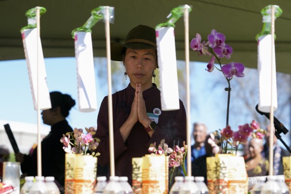 Sasanna Yee prays in front of an altar during a pilgrimage, Saturday, March 16, 2024, in Antioch, Calif. Yee is the granddaughter of Yik Oi Huang, who was fatally beaten in January 2019 in a San Francisco park. (AP Photo/Godofredo A. Vasquez)