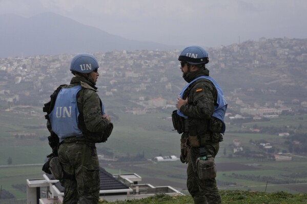 Spanish U.N. peacekeepers stand on a hill overlooking the Lebanese border villages with Israel in Marjayoun town on Wednesday, Jan. 10, 2024. (AP Photo/Hussein Malla)