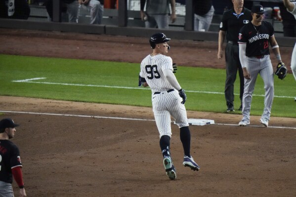 New York Yankees' Aaron Judge (99) runs to third base on a two-run triple against the Minnesota Twins during the fifth inning of a baseball game Wednesday, June 5, 2024, in New York. (AP Photo/Frank Franklin II)
