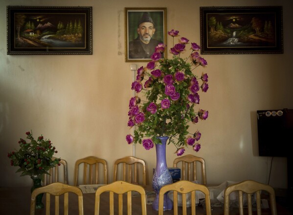 FILE - A picture of Afghan President Hamid Karzai hangs on a wall in the main room of the district municipality in eastern Kabul, Afghanistan, March 29, 2014, ahead of the April 5, 2014, election to choose a new president. (AP Photo/Anja Niedringhaus, File)