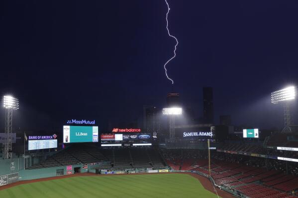 Lightning strikes the Prudential Tower beyond Fenway Park during a rain delay before a baseball game between the Boston Red Sox and the Tampa Bay Rays, Friday, June 2, 2023, in Boston. The game was postponed. (AP Photo/Michael Dwyer)