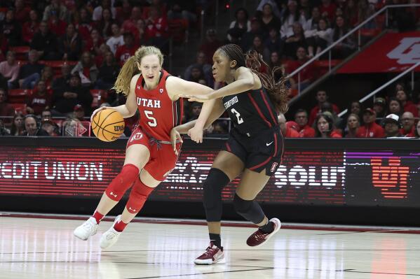 Utah guard Gianna Kneepkens (5) drives against Stanford guard Agnes Emma-Nnopu (2) in the second half of an NCAA college basketball game Saturday, Feb. 25, 2023, in Salt Lake City. (AP Photo/Rob Gray)