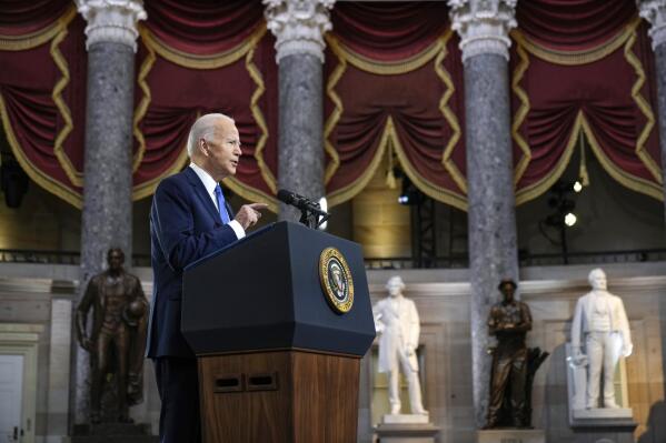 President Joe Biden delivers remarks on the one year anniversary of the January 6 attack on the U.S. Capitol, during a ceremony in Statuary Hall, Thursday,  Jan. 6, 2022 at the Capitol in Washington. (Drew Angerer/Pool via AP