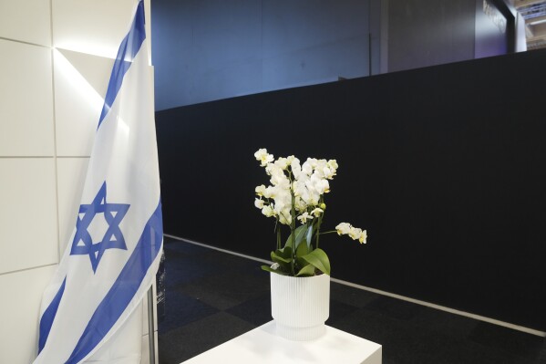 An Israeli flag is seen next to a black wall that blocks the Israeli pavilions erected at the Paris Air Show , Monday, June 16, 2025 in Le Bourget, north of Paris. (AP Photo/Michel Euler)