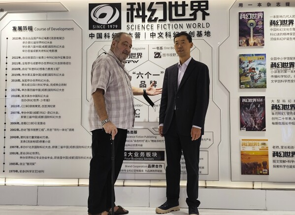In this photo taken on Oct. 26, 2024, and released by Yao Haijun, Yao, the editor in chief of China's Science Fiction World magazine, right, poses for a photo with American sci-fi writer David Wesley Hill at the magazine's office in Chengdu in southwestern China's Sichuan province. The magazine organized China's first science fiction conventions, helping to revive the genre after it was largely suppressed by Mao-era censorship. (Yao Haijun via AP)