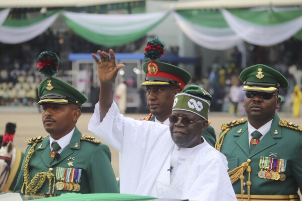 FILE- Nigeria's new President Bola Ahmed Tinubu inspects honour guards after taking an oath of office at a ceremony in Abuja, Nigeria, Monday, May 29, 2023. Nigeria's President Bola Tinubu forwarded 28 ministerial nominees to federal legislators on Thursday July 27 for confirmation as he seeks to finally set up his cabinet to lead Africa's most populous country. (AP Photo/Olamikan Gbemiga, File)