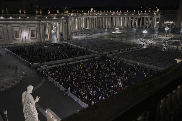 Catholic worshippers pray the rosary for Pope Francis in St. Peter's Square at The Vatican, Friday, March 7, 2025. (AP Photo/Francisco Seco)