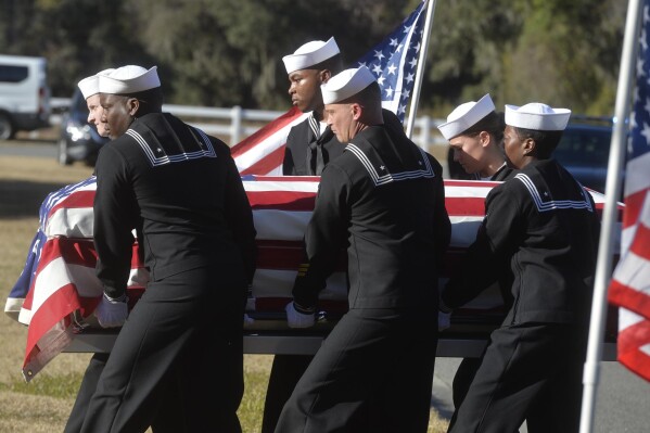FILE - Sailors carry the casket of Cameron Walters at Oak Hill Cemetery in Richmond Hill, Ga., Monday, Dec. 16, 2019. A Florida judge has dismissed a lawsuit against Saudi Arabia over a 2019 mass shooting at the Pensacola Naval Air Station that killed three US service members and wounded several others. (Steve Bisson/Savannah Morning News via AP)