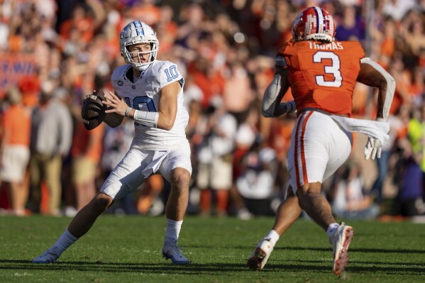 Clemson defensive end Xavier Thomas (3) pressures North Carolina quarterback Drake Maye (10) during the first half of an NCAA college football game Saturday, Nov. 18, 2023, in Clemson, S.C. (AP Photo/Jacob Kupferman)