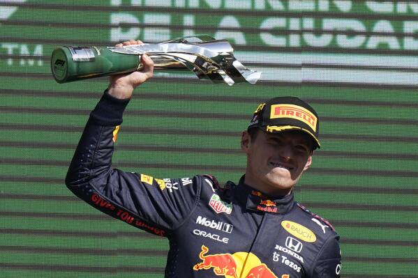 Red Bull driver Max Verstappen, of The Netherlands, celebrates with the trophy after winning the Formula One Mexico Grand Prix auto race at the Hermanos Rodriguez racetrack in Mexico City, Sunday, Nov. 7, 2021. (AP Photo/Eduardo Verdugo)