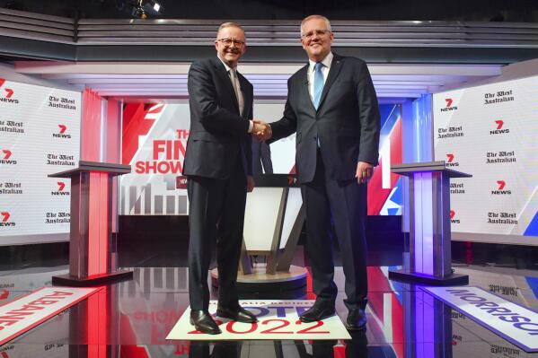 Australian Prime Minister Scott Morrison, right and Australian Opposition Leader Anthony Albanese shake hands ahead of the leaders' debate in Sydney, Australia, Wednesday, May 11, 2022. A Chinese ambassador says China's engagement with South Pacific island countries poses no threat to Australia, responding to fears that Beijing will establish a military foothold in the Solomon Islands. (Mick Tsikas/Pool Photo via AP)