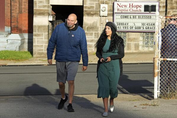 FILE - Pennsylvania Lt. Gov. John Fetterman and wife Gisele arrive to vote in Braddock, Pa, Tuesday, Nov. 8, 2022. When Fetterman goes to Washington in January, one of the Senate's new members will bring along an irreverent style from Pennsylvania that extends from his own personal dress code — super casual — to hanging marijuana flags outside his current office in Pennsylvania's state Capitol. (AP Photo/Gene J. Puskar, File)