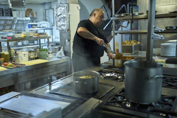A chef cooks at Casa Pedro restaurant in Madrid, Spain, on May 16, 2025. (AP Photo/Manu Fernandez)