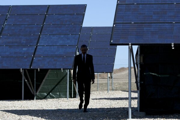 
              FILE - In this Friday, April 3, 2015 file photo, President Barack Obama walks through a solar array at Hill Air Force Base, Utah to speak about clean energy and the jobs numbers. Driven by concerns about rising global greenhouse gas emissions, President Donald Trump’s rollback of the Obama administration’s Clean Power Plan and his plans to pull the United States out of the 2015 Paris climate agreement, some states are turning to renewable energy targets and energy efficiency programs in hopes of addressing climate change. (AP Photo/Carolyn Kaster)
            