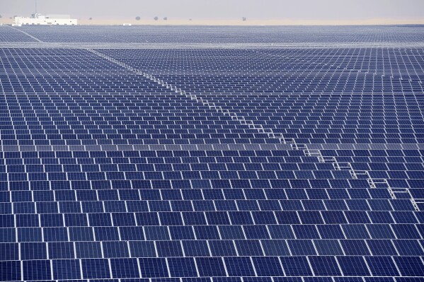 Solar panels operate at Mohammed bin Rashid Al Maktoum Solar Park as Dubai, United Arab Emirates hosts the COP28 U.N. Climate Summit, Monday, Dec. 11, 2023. Solar is now the cheapest form of electricity in a majority of countries. (AP Photo/Joshua A. Bickel)