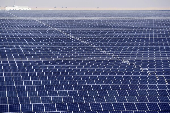 Solar panels operate at Mohammed bin Rashid Al Maktoum Solar Park as Dubai, United Arab Emirates hosts the COP28 U.N. Climate Summit, Monday, Dec. 11, 2023. Solar is now the cheapest form of electricity in a majority of countries. (AP Photo/Joshua A. Bickel)