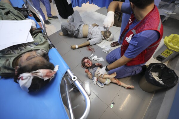 Palestinians wounded in Israeli strikes are brought to Shifa Hospital in Gaza City on Wednesday, Oct. 11, 2023. (AP Photo/Ali Mahmoud)