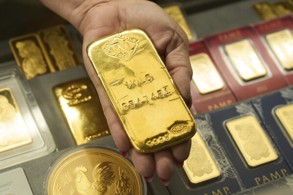 Sam Nguyen shows a gold bar at her shop in the St. Vincent Jewelry Center in the Jewelry District of Los Angeles, Wednesday, April 30, 2025. (AP Photo/Jae C. Hong)