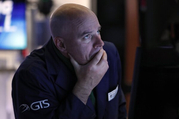 Specialist John O'Hara works at his post on the floor of the New York Stock Exchange, Thursday, March 12, 2020. The stock market had its biggest drop since the Black Monday crash of 1987 as fears of economic fallout from the coronavirus crisis deepened. The Dow industrials plunged more than 2,300 points, or 10%. The vast majority of people recover from the new coronavirus. According to the World  Health Organization, most people recover in about two to six weeks, depending on the severity of the illness. (AP Photo/Richard Drew)