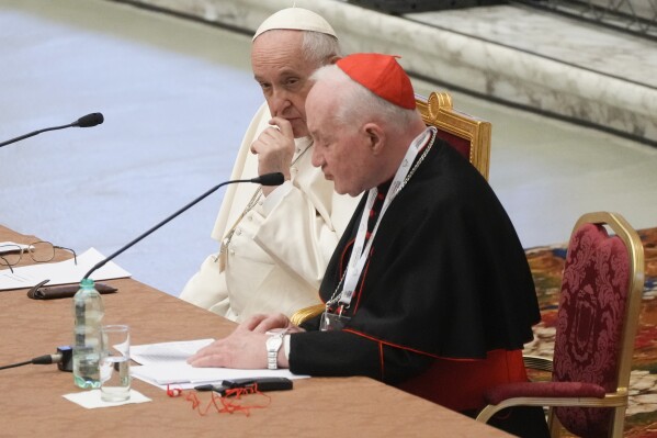 FILE - Pope Francis, left, listens to Cardinal Marc Ouellet's opening address as he attends the opening of a 3-day Symposium on Vocations in the Paul VI hall at the Vatican, Thursday, Feb. 17, 2022. The Holy See has formally protested to France after a French court ruled that a former high-ranking Vatican official was liable for what the court determined to be the wrongful dismissal of a nun from a religious order. (AP Photo/Gregorio Borgia, File)