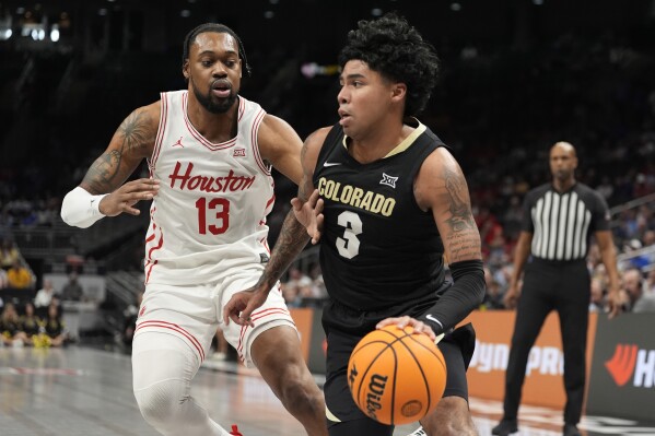 Colorado's Julian Hammond III (3) drives to the basket past Houston's J'Wan Roberts (13) during the first half of an NCAA college basketball game in the quarterfinal round of the Big 12 Conference tournament, Thursday, March 13, 2025, in Kansas City, Mo. (AP Photo/Charlie Riedel)