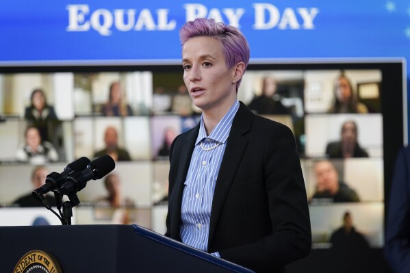 FILE - United States Soccer Women's National Team member Megan Rapinoe speaks during an event to mark Equal Pay Day in the South Court Auditorium in the Eisenhower Executive Office Building on the White House Campus, Wednesday, March 24, 2021, in Washington. Whether she was advocating for equal pay and racial justice or just scoring a rare goal off a corner kick, Megan Rapinoe was always unabashedly authentic during her soccer career. (AP Photo/Evan Vucci, File)