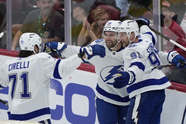 Tampa Bay Lightning center Steven Stamkos, right, celebrates his goal with center Anthony Cirelli (71) and left wing Brandon Hagel, center, during the first period of an NHL hockey game against the Florida Panthers, Saturday, March 16, 2024, in Sunrise, Fla. (AP Photo/Wilfredo Lee)