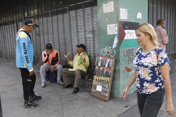 Remote controls are displayed for sale on a street corner in downtown Maracay, Venezuela, Saturday, March 22, 2025. (AP Photo/Cristian Hernandez)