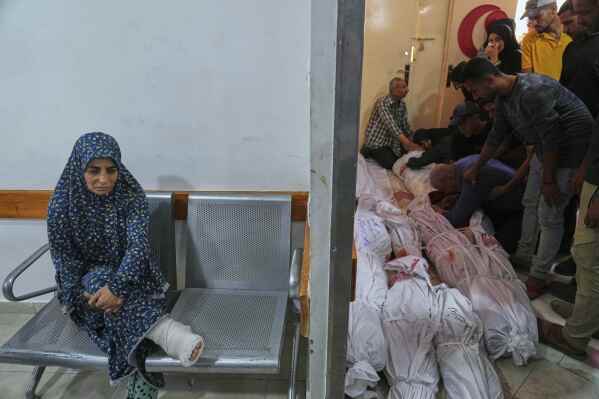 Palestinians mourn their relatives killed in an Israeli airstrikes in Jabalia, northern Gaza Strip, on Wednesday, May 14, 2025. According to local hospitals, 48 people were killed in the strikes, including 22 children. (AP Photo/Jehad Alshrafi)
