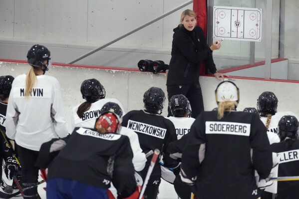FILE- Courtney Kessel, head coach of the Boston-based team of the Professional Women's Hockey League, instructs her players during a team hockey practice ahead of their season, Monday, Nov. 20, 2023, in Wellesley, Mass. (AP Photo/Charles Krupa, file)