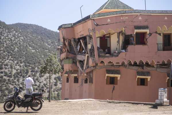 A man stands next to a damaged hotel after the earthquake in Moulay Brahim village, near the epicentre of the earthquake, outside Marrakech, Morocco, Saturday, Sept. 9, 2023. A rare, powerful earthquake struck Morocco late Friday night, killing more than 800 people and damaging buildings from villages in the Atlas Mountains to the historic city of Marrakech. But the full toll was not known as rescuers struggled to get through boulder-strewn roads to the remote mountain villages hit hardest. (AP Photo/Mosa'ab Elshamy)