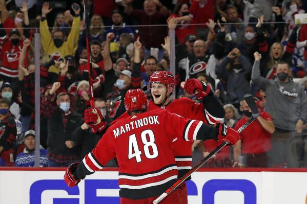 Carolina Hurricanes' Steven Lorentz (78) celebrates his goal with teammate Jordan Martinook (48) during the second period of an NHL hockey game against the Toronto Maple Leafs in Raleigh, N.C., Monday, Oct. 25, 2021. (AP Photo/Karl B DeBlaker)