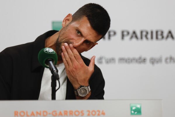 Serbia's Novak Djokovic ponders a question during a press conference ahead his first round match of the French Open tennis tournament at the Roland Garros stadium in Paris, Sunday, May 26, 2024. (AP Photo/Jean-Francois Badias)