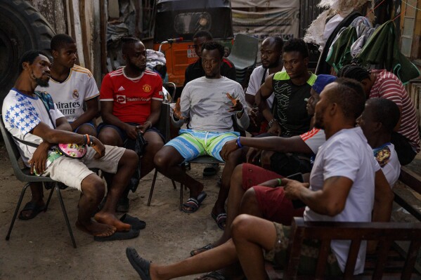 A group of youth meet in Bombay Street in a compound where they rehabilitate Kush users in Freetown, Sierra Leone, Saturday, April 28, 2024. Youth in the Bombay community are helping Kush addicts stop by rehabilitating them in a temporary space. Sierra Leone declared a war on the cheap synthetic drug, calling it an epidemic and a national threat. The drug is ravaging youth, and healthcare services are severely limited. (AP Photo/ Misper Apawu)