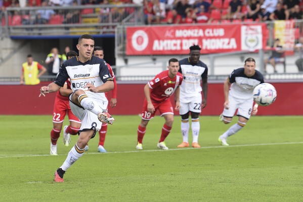 Lecce's Nikola Krstovic scores their side's first goal of the Serie A soccer match between Monza and Lecce at the U-Power stadium in Monza, Italy, Sunday Sept. 17, 2023. (Claudio Grassi/LaPresse via AP)