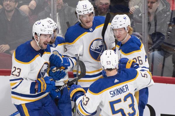 Buffalo Sabres' Tage Thompson (72) celebrates with teammates Mattias Samuelsson (23), Vinnie Hinostroza, Jeff Skinner (53) and Rasmus Dahlin (26) after scoring against the Montreal Canadiens during the third period of an NHL hockey game in Montreal, Tuesday, Nov. 22, 2022. (Graham Hughes/The Canadian Press via AP)