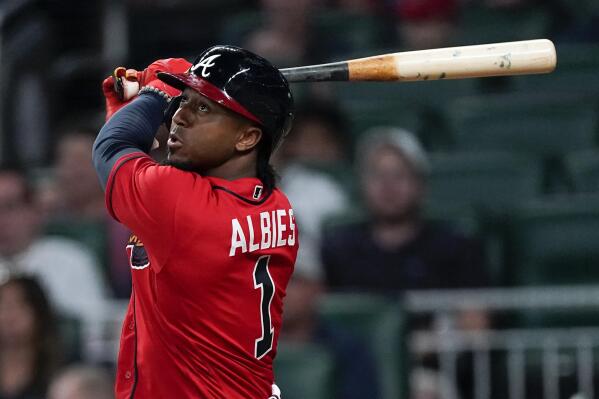 Atlanta Braves' Ozzie Albies watches his two-run double in the seventh inning of a baseball game against the Miami Marlins, Friday, May 27, 2022, in Atlanta, Ga. (AP Photo/John Bazemore)