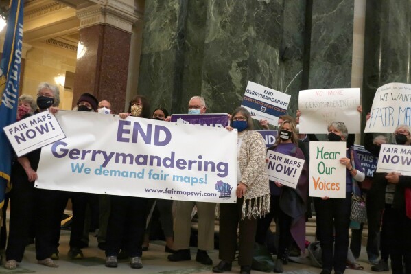 FILE - More than 100 opponents of the Republican redistricting plans vow to fight the maps at a rally ahead of a joint legislative committee hearing at the Wisconsin state Capitol in Madison, Wis., on Thursday, Oct. 28, 2021. Wisconsin Republicans have enjoyed outsize control of the Legislature in one of the most closely divided states for a dozen years. Maintaining that power is now at the heart of a drama involving the state Supreme Court that has national political implications. (AP Photo/Scott Bauer, File)