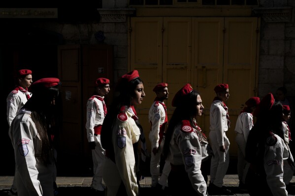 Scouts line up during the traditional Christian procession towards the Church of the Nativity, traditionally believed to be the birthplace of Jesus, on Christmas Eve, in the West Bank city of Bethlehem, Tuesday, Dec. 24, 2024. (AP Photo/Matias Delacroix)