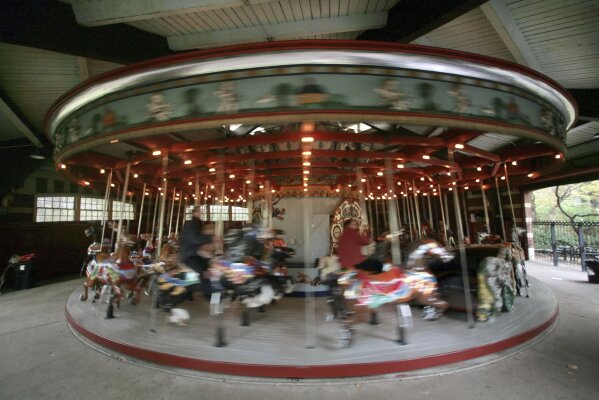 FILE - This Nov. 14, 2007 file photo shows the carousel in Central Park, in New York. New York City will terminate business contracts with President Donald Trump after last week's insurrection at the U.S. Capitol, Mayor Bill de Blasio announced Wednesday, Jan. 13, 2021. The Trump Organization is under city contract to operate the two ice rinks and a carousel in Central Park as well as a golf course in the Bronx.   (AP Photo/Bebeto Matthews, File)