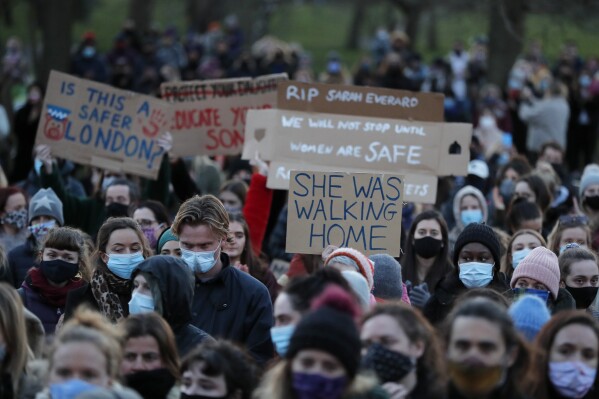 FILE - People gather, at the band stand in Clapham Common, in memory of Sarah Everard, after an official vigil was cancelled, in London, Saturday, March 13, 2021. British police have paid damages to two protesters who say they were roughed up and arrested while attending a vigil for a woman murdered by a police officer. Patsy Stevenson and Dania Al-Obeid were detained at the March 2021 event in London, which police said violated pandemic lockdown rules in place at the time. (AP Photo/Frank Augstein, File)