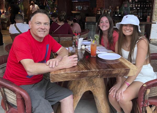 This Dec. 2021 photo provided by Jazzmin Kernodle shows father Jeff Kernodle, left, Xana, middle, and Jazzmin, in Puerto Vallarta, Mexico.  Xana was among one of four University of Idaho students found stabbed to death in an off-campus rental home on Nov. 13, 2022. (Courtesy of Jazzmin Kernodle via AP)