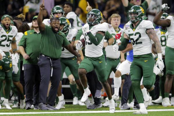 Baylor cornerback Al Walcott (13) runs 96 yards for a touchdown after intercepting a pass during the Sugar Bowl NCAA college football game against Mississippi Saturday, Jan. 1, 2022 in New Orleans. (David Grunfeld/The Times-Picayune/The New Orleans Advocate via AP)