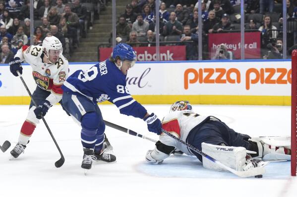 Toronto Maple Leafs forward William Nylander (88) scores against Florida Panthers goaltender Sergei Bobrovsky (72) as forward Carter Verhaeghe (23) watches during overtime in an NHL hockey game Tuesday, Jan. 17, 2023, in Toronto. (Nathan Denette/The Canadian Press via AP)