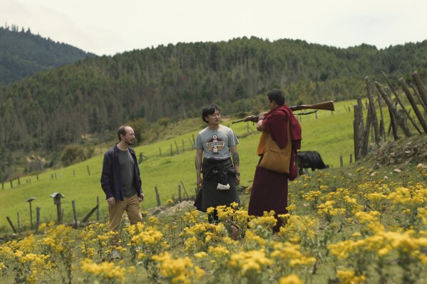 This image released by Roadside Attractions shows Harry Einhorn, from left, Tandin Sonam and Tandin Wangchuk in a scene from "The Monk and the Gun." (Roadside Attractions via AP)