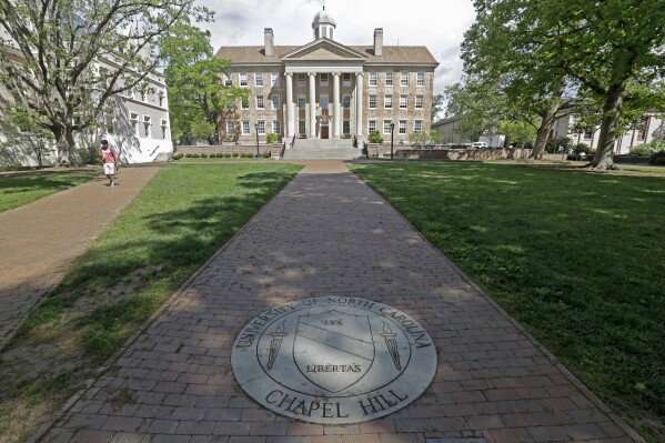 FILE - In this Monday, April 20, 2015, photo, a sidewalk leads to the South Building on campus at The University of North Carolina in Chapel Hill, N.C. The University of North Carolina Board of Governors is expected to vote on repealing and replacing its diversity policy that impacts 17 schools across the state. The board's agenda says the vote will occur on Thursday, May 23, 2024. (AP Photo/Gerry Broome, File)
