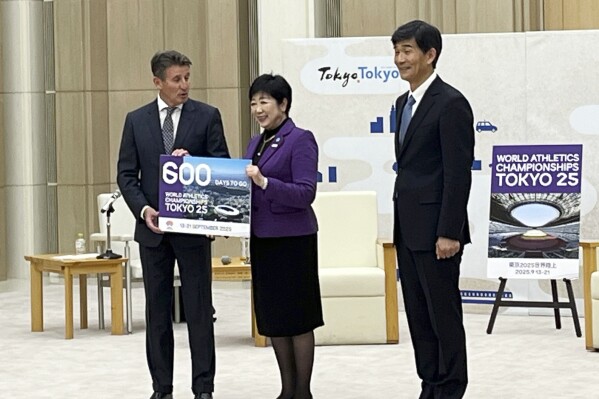 Sebastian Coe, left, the president of World Athletics, meets with Tokyo Gov. Yuriko Koike in Tokyo, Monday, Jan. 22, 2024. “We are all looking forward to being here in Tokyo in a year's time to celebrate a world championships in a stadium — on this occasion — with spectators,” Coe said Monday at a news conference in Tokyo to promote the event. (AP Photo/Stephen Wade)